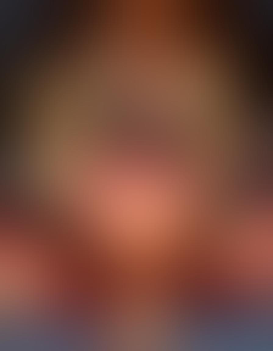 A pair of hands gently holding a delicate heart-shaped pendant, surrounded by soft, glowing candles and rose petals, symbolizing tenderness and intimacy. In the background, a blurred silhouette of a couple sharing a loving gaze, capturing the essence of romance. The color palette should feature warm, inviting tones like soft pinks and oranges. super-realistic. vibrant colors.